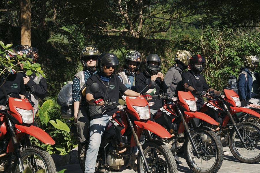 Riders in helmets and protective gear lined up on their bikes before setting off