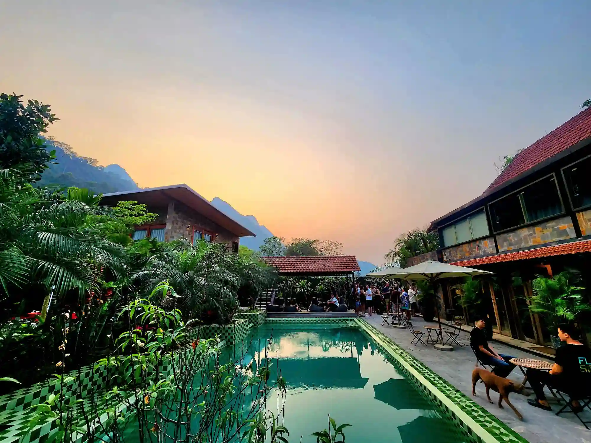 The pool at the Flipside villa at sunset, with the karst hills behind it